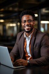 A corporate photograph of a successful black businessman in a suit working on his laptop at the office, an AI-generated image
