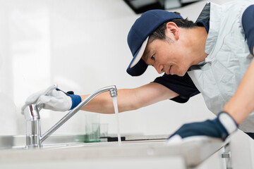 蛇口の点検をする作業員の男性
