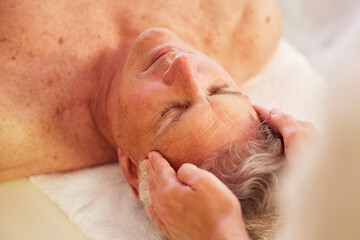 Spa, head massage and senior man for luxury, self care and muscle healing treatment for relaxation. Health, wellness and elderly male person on a retirement retreat for face therapy at natural salon.