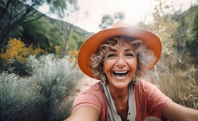 Smiling senior woman taking selfie while travelling alone in summer - obrazy, fototapety, plakaty