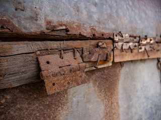 The house door hinges are damaged and rusty
