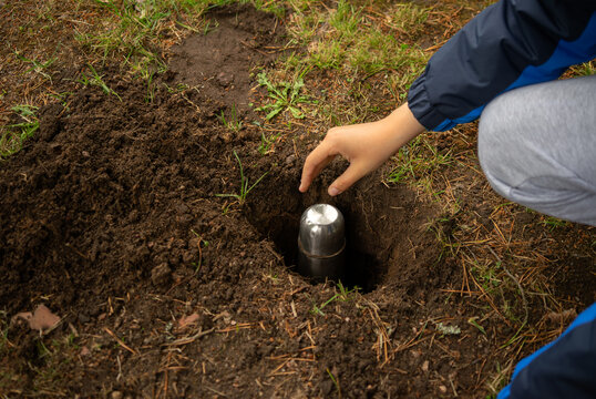 Bury the time capsule in the ground.A message for posterity in an iron bottle.Hide the jewels in the ground. Lower the bottle with the message into the pit.