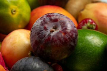 Selective focus red plums. Fresh fruits. Colorful fruit background