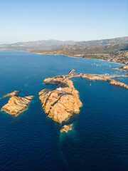 Aerial view of La Pietra lighthouse and island at Ile Rousse in Corsica - 654747973