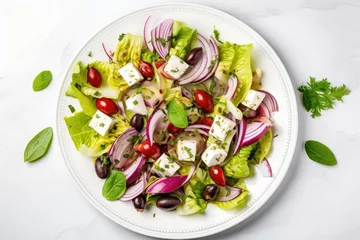 Poster Top down view of a white plate with a green summer salad made with artichokes olives cheese and red onions on a marble table © The Big L