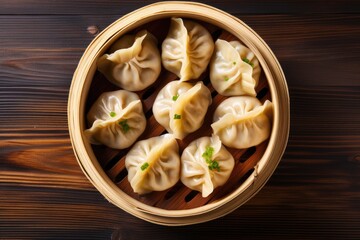 Top view of bamboo steamer containing momo dumplings on wooden background - obrazy, fototapety, plakaty