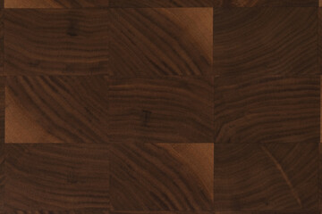 Black walnut end grain wood cutting board texture with oil finish closeup
