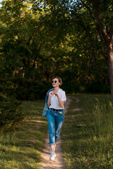 Woman in sunglasses walking in the park