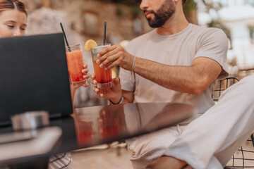 A group of creative professionals discussing trends and analyzing data at a cafe bar, strategizing for online retail success.