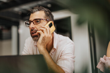 Male, middle-aged broker having a phone call.