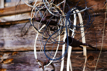 twisted blue and white wires, old wooden building