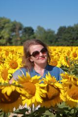 Portrait of a young woman against a background of sunflowers.