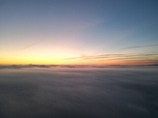 Fototapeta na wymiar Sunrise above the clouds seen from drone