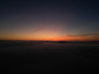 Sunrise above the clouds seen from drone