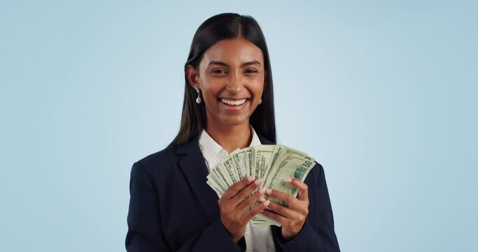 Business woman, cash and money success with financial investment or bonus, profit and winning in studio. Face of indian person, entrepreneur or winner for savings, lottery or sales on blue background