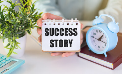 Success story text on blank business card in hand