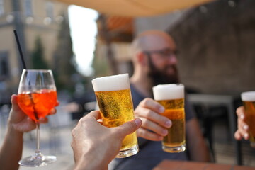 person holding a glass of beer for aperitivo in italy