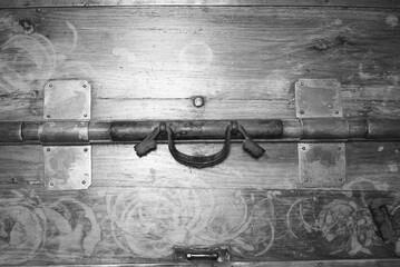 An ancient Asian furniture closure mechanism in black and white.