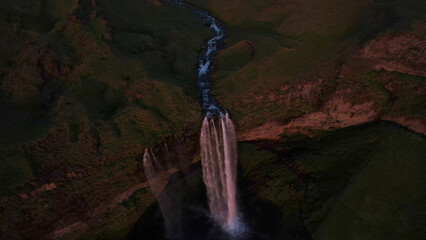 The Seljalandsfoss waterfall on the south coast of Iceland bathed in the otherworldly light of the...