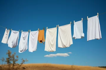 Poster Clothes on a line dance in the wind, drying naturally © Jawed Gfx