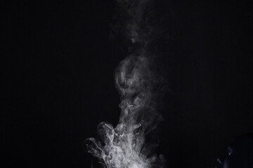 Smoke, vapor or gas in a studio with dark background by mockup space for magic effect with abstract. Incense, steam or fog mist moving in air for cloud smog pattern by black backdrop with mock up.
