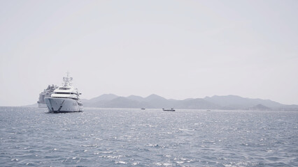 Luxury yacht cruising out at sea. Action. Aerial view of luxury yacht and cruise ship pm rippling water surface. © Media Whale Stock