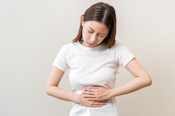 Flatulence asian young woman intolerance hand in stomach ache, suffer from food poisoning,...