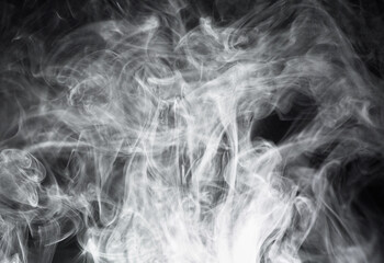 Smoke, steam or gas in a studio with dark background by mockup space for magic effect with abstract. Incense, fog or vapor mist moving in air for cloud smog pattern by black backdrop with mock up