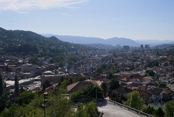Sarajevo, Bosnia and Herzegovina - Sep 27, 2023: Distant view of Sarajevo city in Bosnia and Herzegovina federation from the surrounding viewpoints in a sunny summer afternoon. Selective focus.