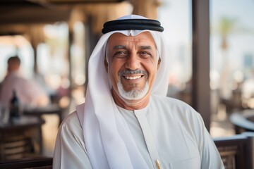 portrait of senior old arab man in dubai wearing white arabic clothes - obrazy, fototapety, plakaty
