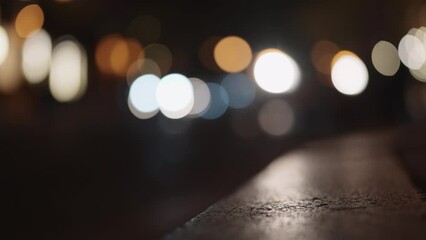 Bokeh background of night city with car light passing by