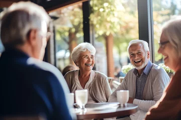 Foto op Canvas group of senior old people joking and talking in a restaurant or cafe © Salsabila Ariadina