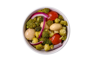 Delicious fresh salad with broccoli, cherry tomatoes, mushrooms, onions, salt, spices and herbs