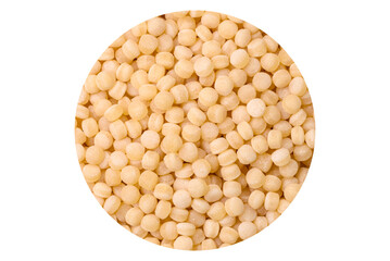 Raw ptitim pasta in a ceramic bowl on a dark concrete background