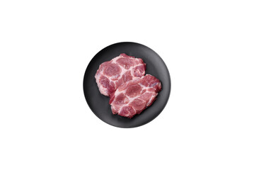 Fresh juicy pork steaks with salt, spices and herbs