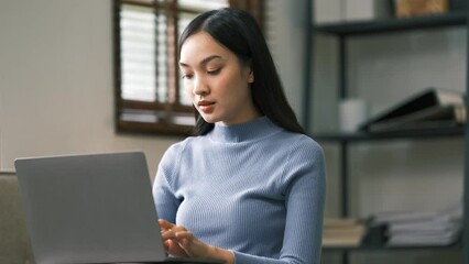 Asian charming person sit hold netbook browsing have good mood working home indoors.