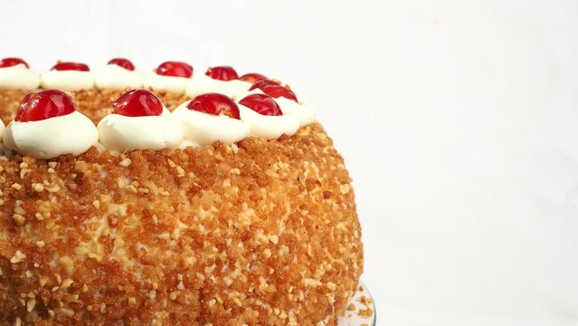 Frankfurt Kranz Torte, also known simply as Kranz in Germany, is a classic and beloved German dessert. The cake rotates on a white background.