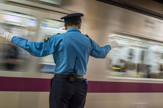 Platform attendant (Oshiya) working in Tokyo Metro Subway, Japan