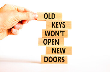 Old keys do not open new doors symbol. Concept words Old keys do not open new doors. Beautiful white table background. Businessman hand. Business popular quotation old key new door concept Copy space