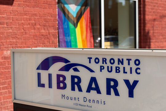 Toronto Public Library - Mount Dennis Branch - close-up of illuminated box sign with windows and Freedom Flag