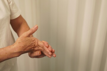 A woman uses her other hand to feel pain and tingling. along with Guillain-Barre syndrome and...