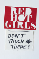red card stock stencil with "red hot girls" cutout and a handwritten note in black marker: "don't touch me there"