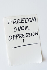 handwritten black felt-tip marker note: freedom over oppression! - obrazy, fototapety, plakaty