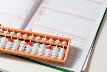 Japanese traditional abacus soroban on white background. Child using abacus. Education and development concept. Back to school, math education, mental mathematics, arithmetic