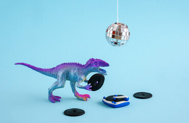 Cute blue and violet dinosaur toy holding listen vinyl on vinyl record player on blue background.