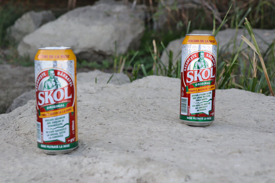 skol beer on aq grey rock outdoors