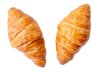 Top view of two separated fresh croissants isolated on white background with clipping path in png file format. Set or collection of croissants