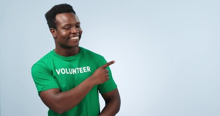 Studio smile, black man and pointing at volunteering information, NGO announcement or community service notification. Recycle, nonprofit climate care or model presentation portrait on blue background