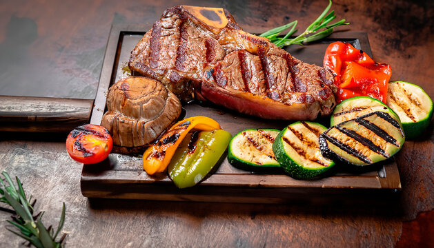 Grilled meat steak on stainless grill