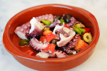 Octopus salad with lemon tomatoes rosemary and vegetables on plate, Fresh and healthy salad seafood squid and octopus